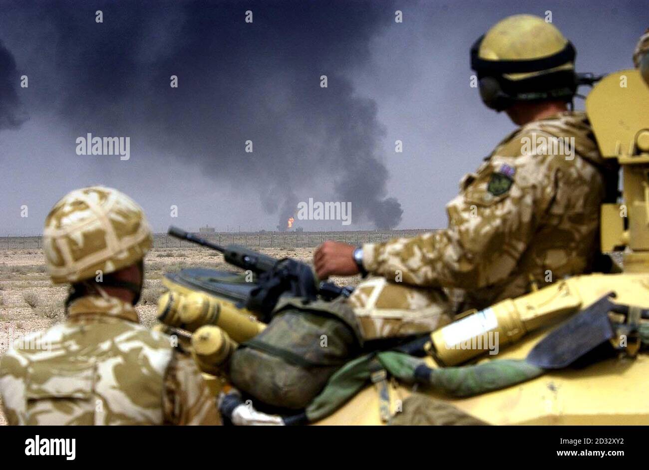 Household Cavalry regiment looking on into southern Iraq at destroyed and burning oil well heads. Stock Photo