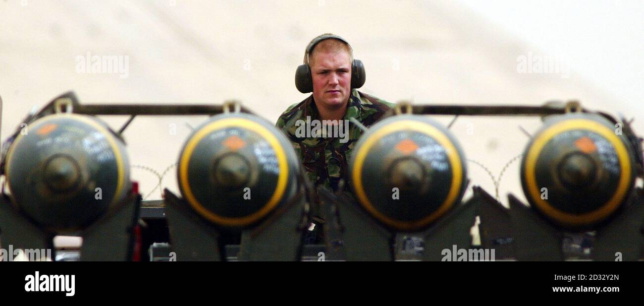 A British Royal Air Force weapons technician Senior Aircraftman Barry Jones, watches as he sits behind a trolly full of 500lb freefall bombs as a British  Harrier GR7 taxis out to the runway on its base in Kuwait.    * Britain said is was almost certain that two dead soldiers whose bodies were shown on Qatar-based al-Jazeera television were indeed British, as the station claimed. Stock Photo