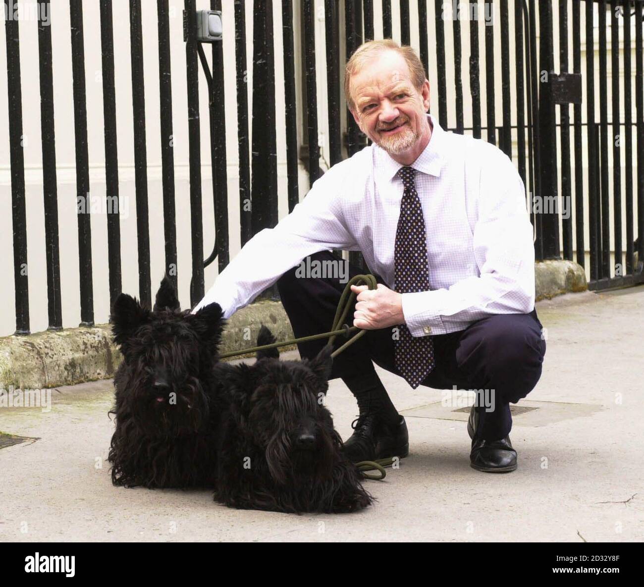Former Leader of the House, Robin Cook, with his dogs Tammy and Tasker, outside the 'grace and favour' London residence he has been urged to leave.  *  Mr Cook has been criticised in some circles for maintaining 1 Carlton Terrace, where he has lived since becoming foreign secretary six years ago, after resigning his cabinet post. Alan Duncan, a Tory foreign affairs spokesman, has urged Tony Blair to evict Mr Cook from the   5-7 million flat immediately. But the Prime Minister's official spokesman said Mr Blair decided Mr Cook could stay until he has found other accomodation.  It is understood  Stock Photo