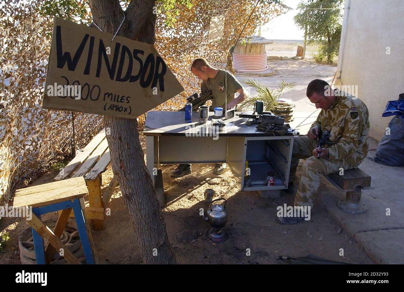 Picture made available Thursday April 3rd 2003 of Household Cavalry regiment (HCR) soldiers clean their weapons during some down time at the camp in southern Iraq. Stock Photo