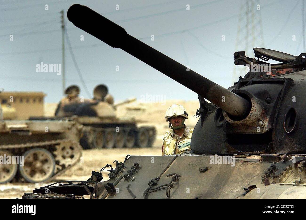 A Para inspects a tank outside the Iraqi barracks after it had been destroyed by a A10 Tankbuster plane in the town of Ad Dayr, north of Basra, Iraq. Stock Photo