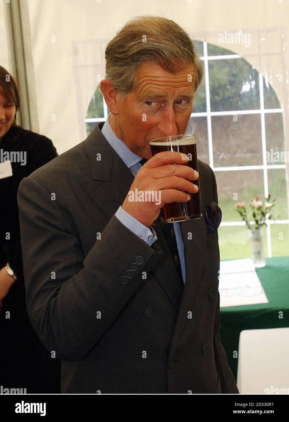 The Prince of Wales samples two locally brewed beers.  First he took a sip of 4.3% Otter Bright, and then the 5.8% Otter Head.  *  Patrick McCaig, from Otter Brewery at Luppitt, gave the Prince a case of their beers as a 21st birthday present for Prince William, in the tent at Highdown Farm at Bradninch, during a visit. Stock Photo