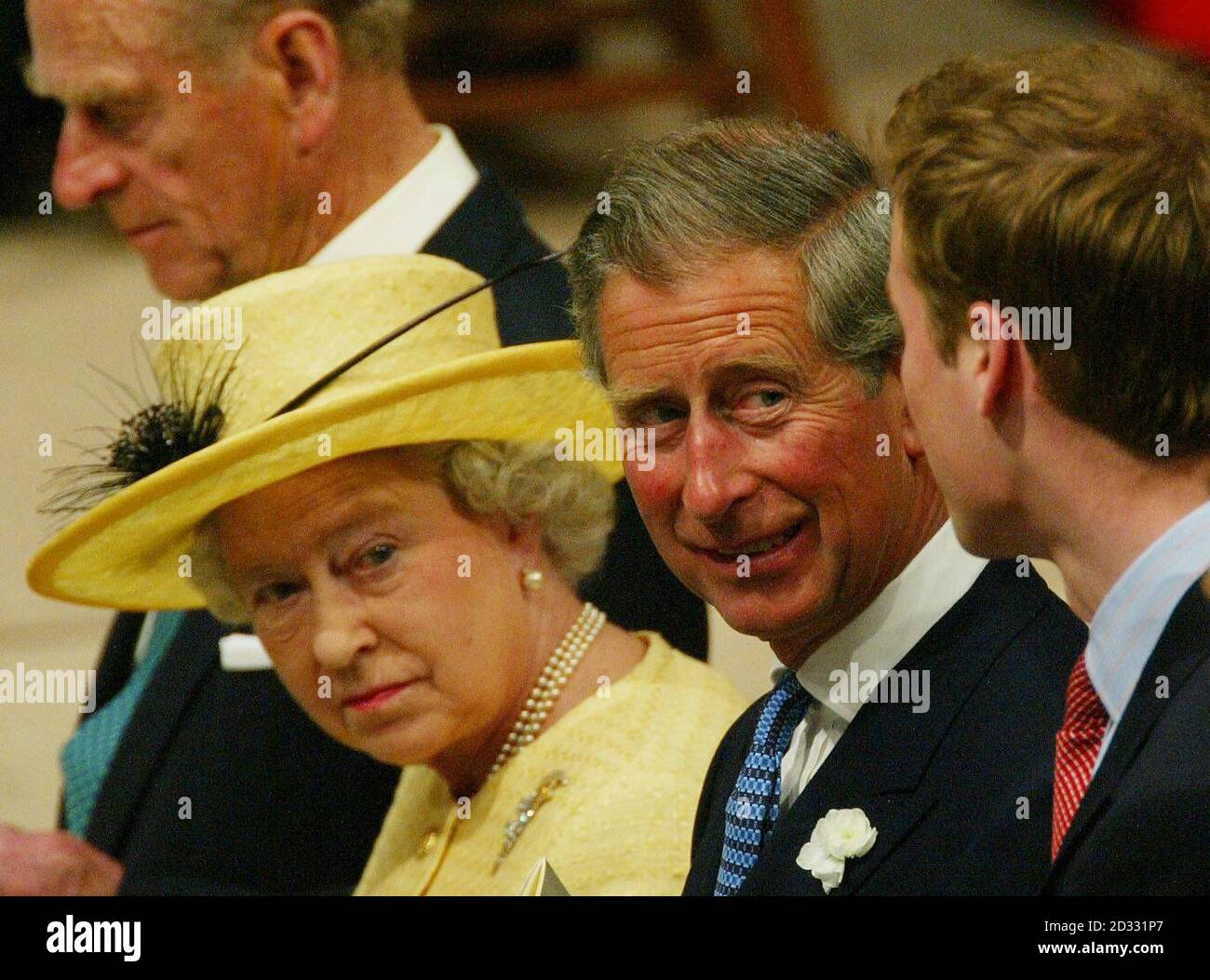 Queen elizabeth ii sits with family members prince of wales and