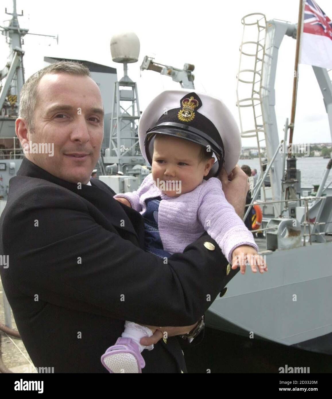 Chief Petty Officer Kevin Smith from Pensilva, Cornwall holds his 10-month-old daughter Emily-Rose, after arriving back on HMS Roebuck at Devonport, Plymouth, from the Gulf.  *   After around six months at sea, the 1,300 tonne coastal survey ship HMS Roebuck and her crew of 53 was docking at Devonport naval base to be greeted by families.  Stock Photo
