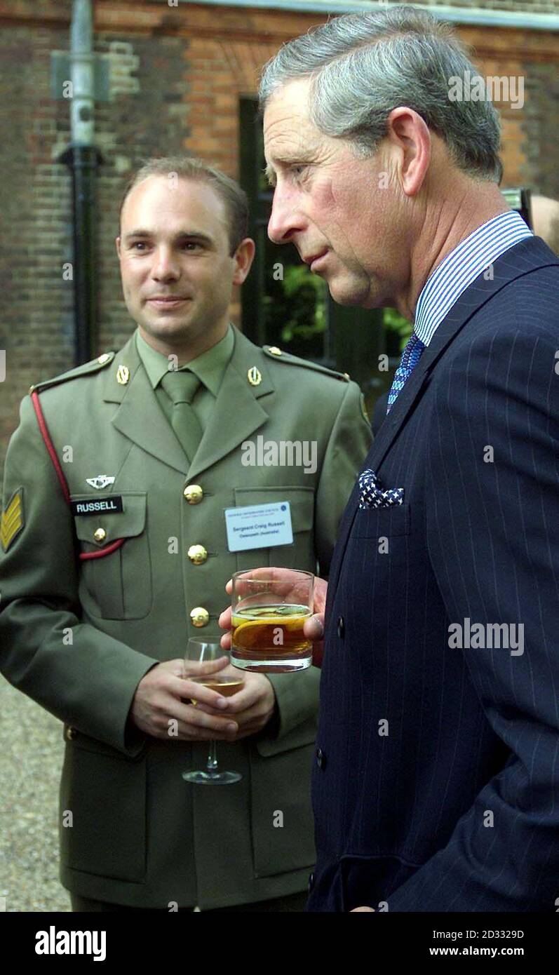 The Prince of Wales in his capacity as Patron of the Osteopathic Council gives a reception in the gardens of St James Palace, to celebrate the council's work. Pictured with the Prince is Australian army Sargeant Craig Russell from Melbourne. Stock Photo