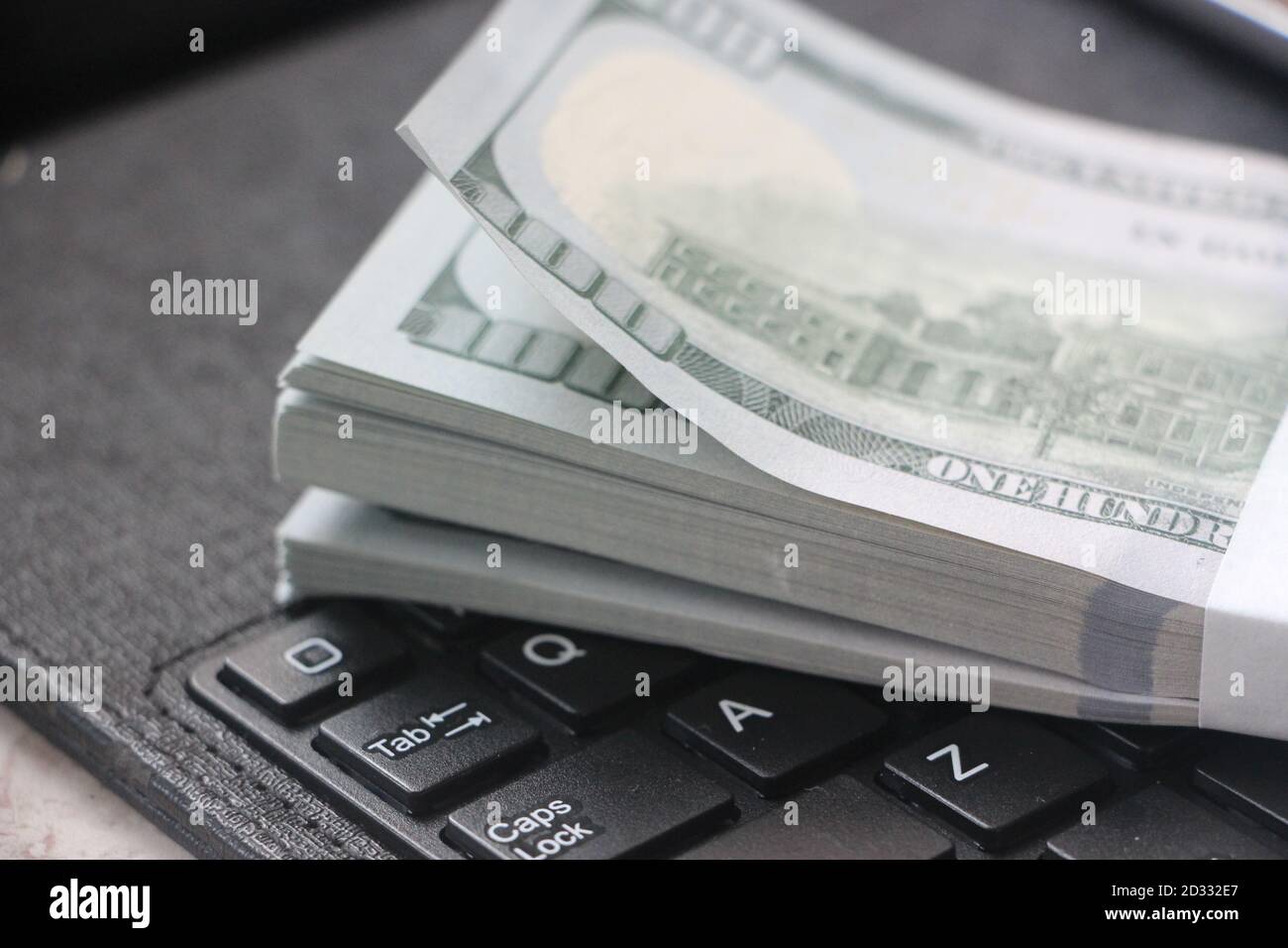 US hundred dollar bills on white modern computer keyboard Stock Photo ...
