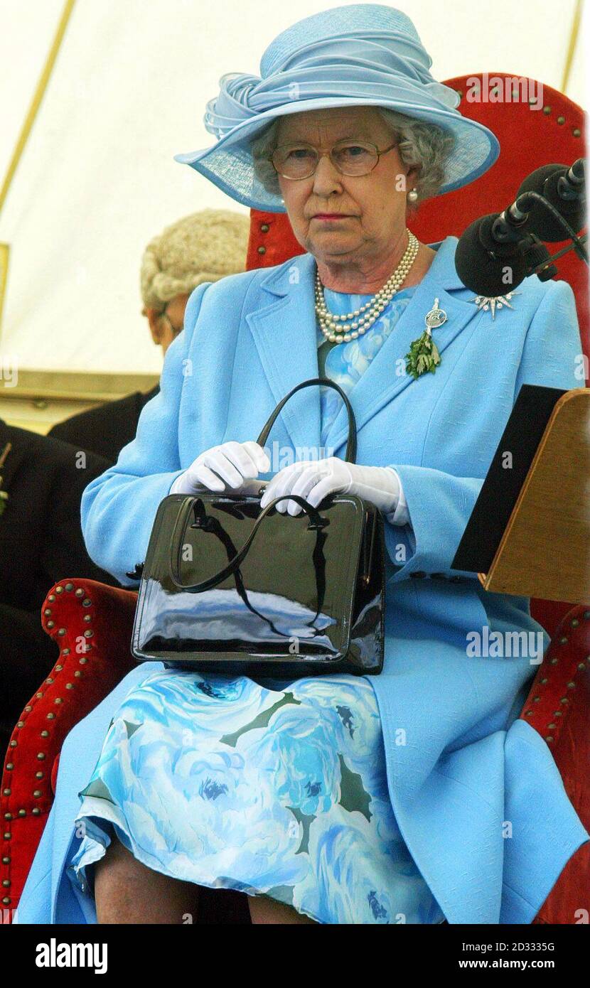 Britain's Queen Elizabeth II holds her handbag as she presides over the  Tynwald ceremony on the Isle of Man Stock Photo - Alamy