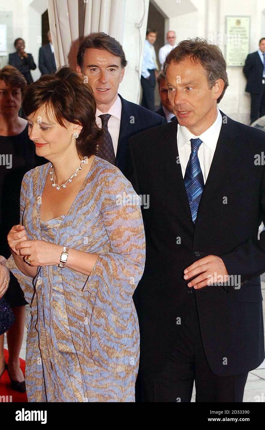 The Prime Minister Tony Blair and wife Cherie arrive at the Guildhall in the City of London, with Peter Mandelson in the background, for the progressive Governance dinner. Stock Photo