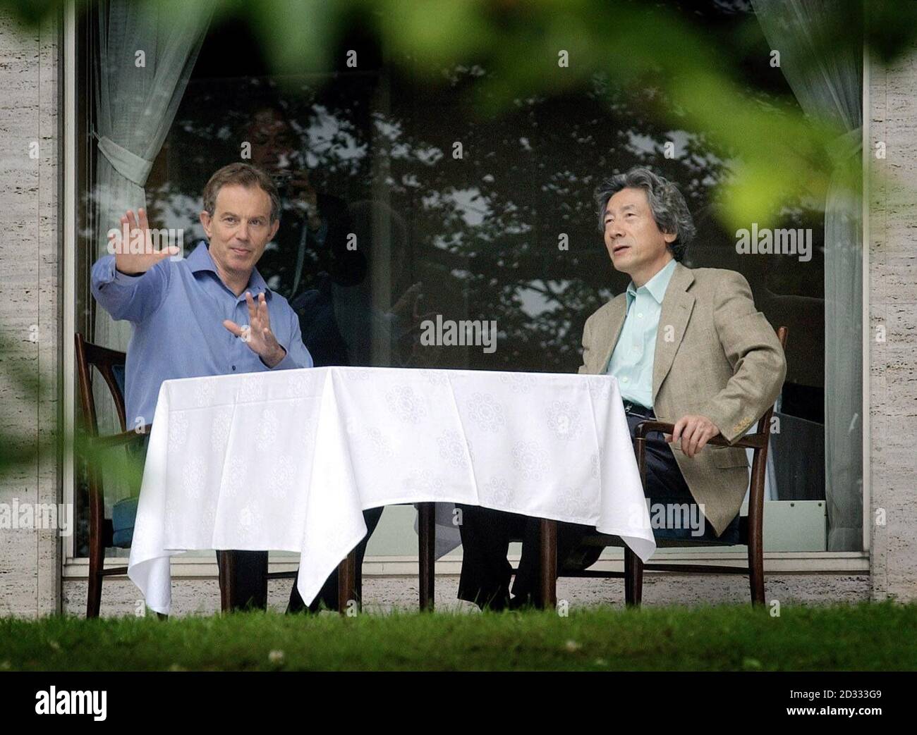 British Prime Minister Tony Blair chats with Japanese Prime Minister Koizumi in the grounds of the Prince Hotel in Hakone, Japan during Tony Blair's week long tour of the far east. Stock Photo