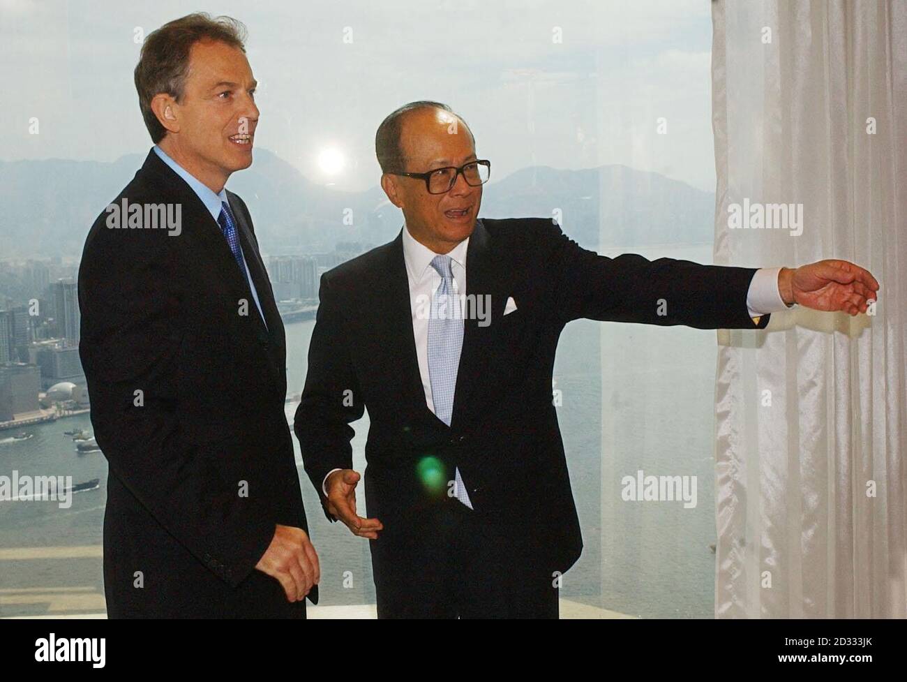 British Prime Minister Tony Blair with leading Hong Kong businessman Dr. Li Ka-Shing. Blair was flying home from Hong Kong, cutting short a Far East visit to avoid being stranded by a typhoon, acting on the advice of the captain of his British Airways chartered Boeing 777 jet. * Blair cancelled a programme of events scheduled for tonight and tomorrow and headed for Heathrow instead. Stock Photo
