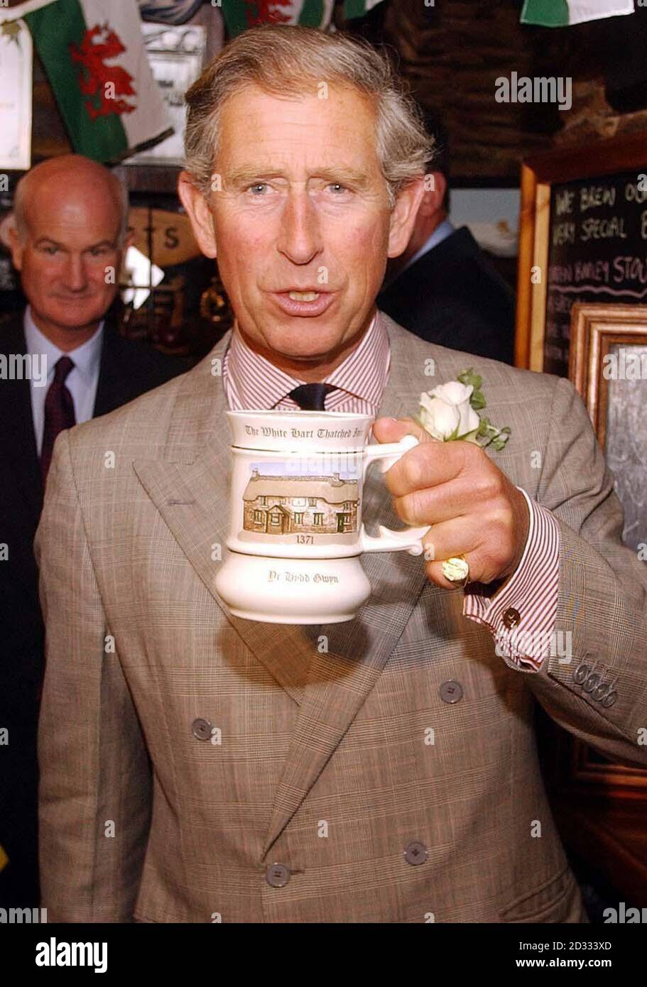 The Prince of Wales with a mug of the local ale at the White Hart pub in the village of Llanddarog, Carmarthenshire, west Wales. The Prince spent the day in the area as part of a four-day tour of Wales, in which he tours the country meeting thousands of the locals. Stock Photo