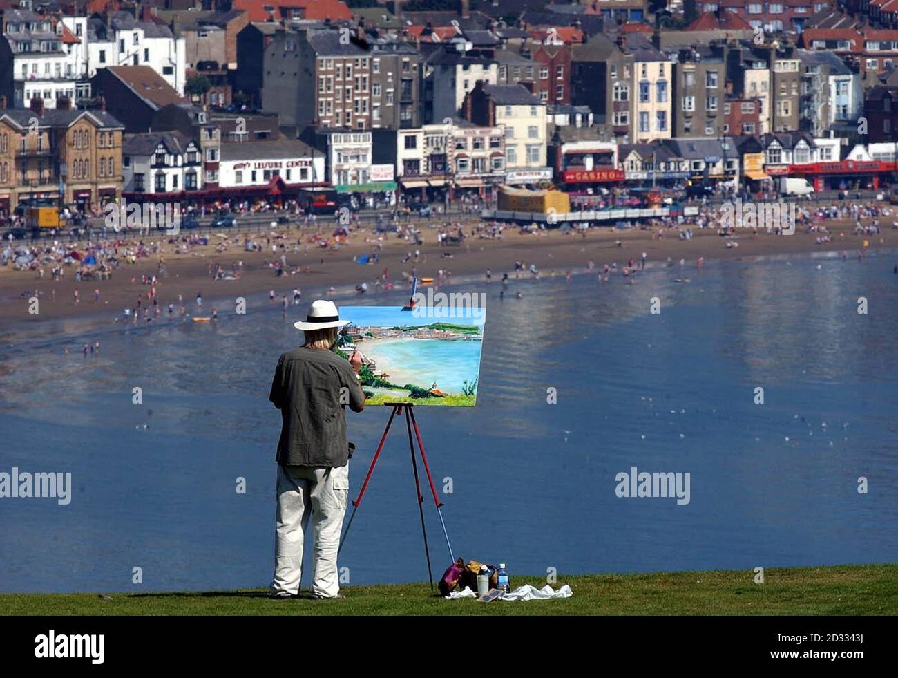 An artist captures the views on his canvas over the beach at Scarborough. The scorching weather is set to continue for at least another two weeks, when millions of Britons will be heading for beaches, parks and beer gardens.Some parts of the country were expected to be even hotter today than Barbados, where Prime Minister Tony Blair is currently enjoying time off with his family.Britain has already seen the third warmest June and July for the last 100 years. Stock Photo
