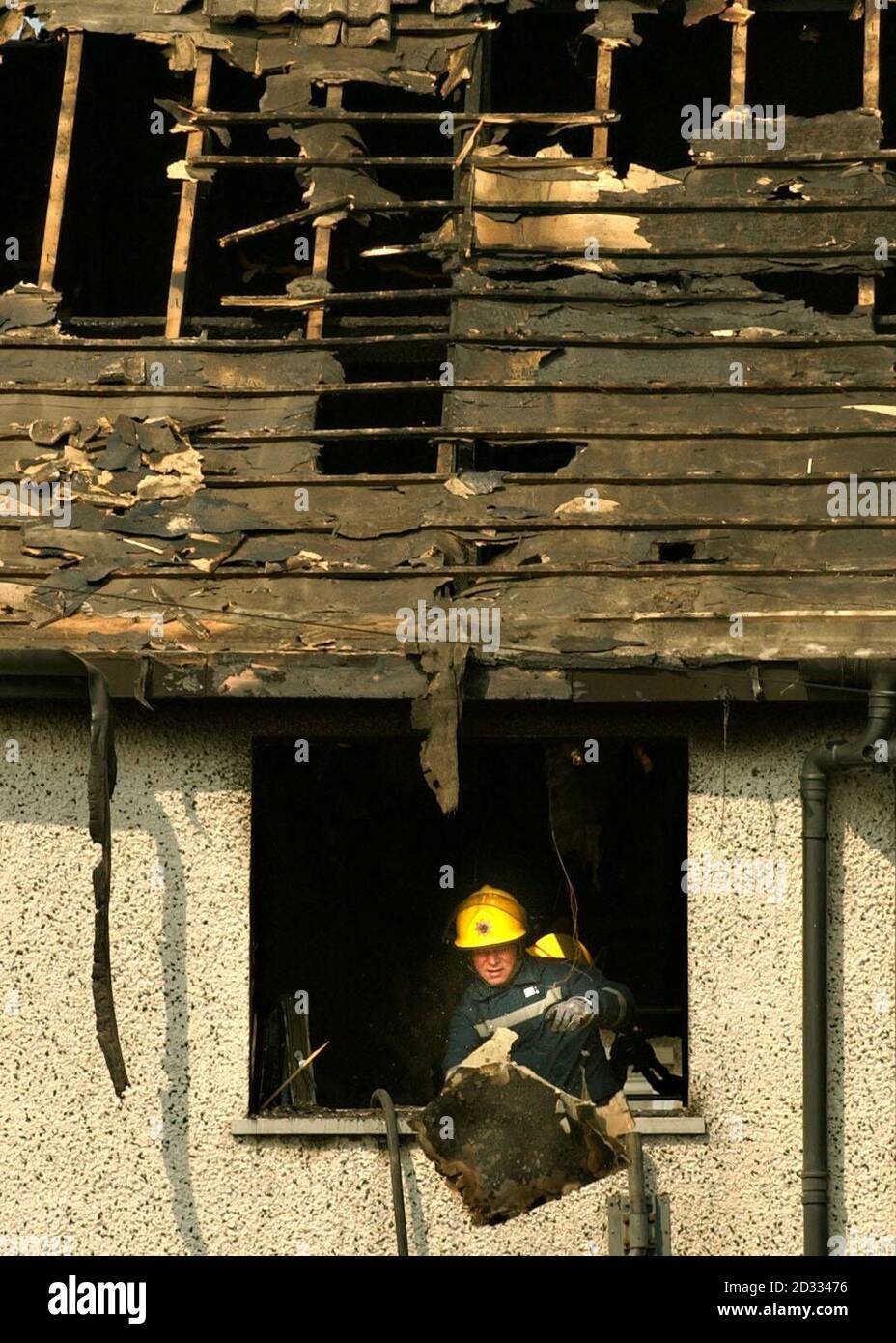 A fireman at the back window of a burnt out house in Falside Terrace ...
