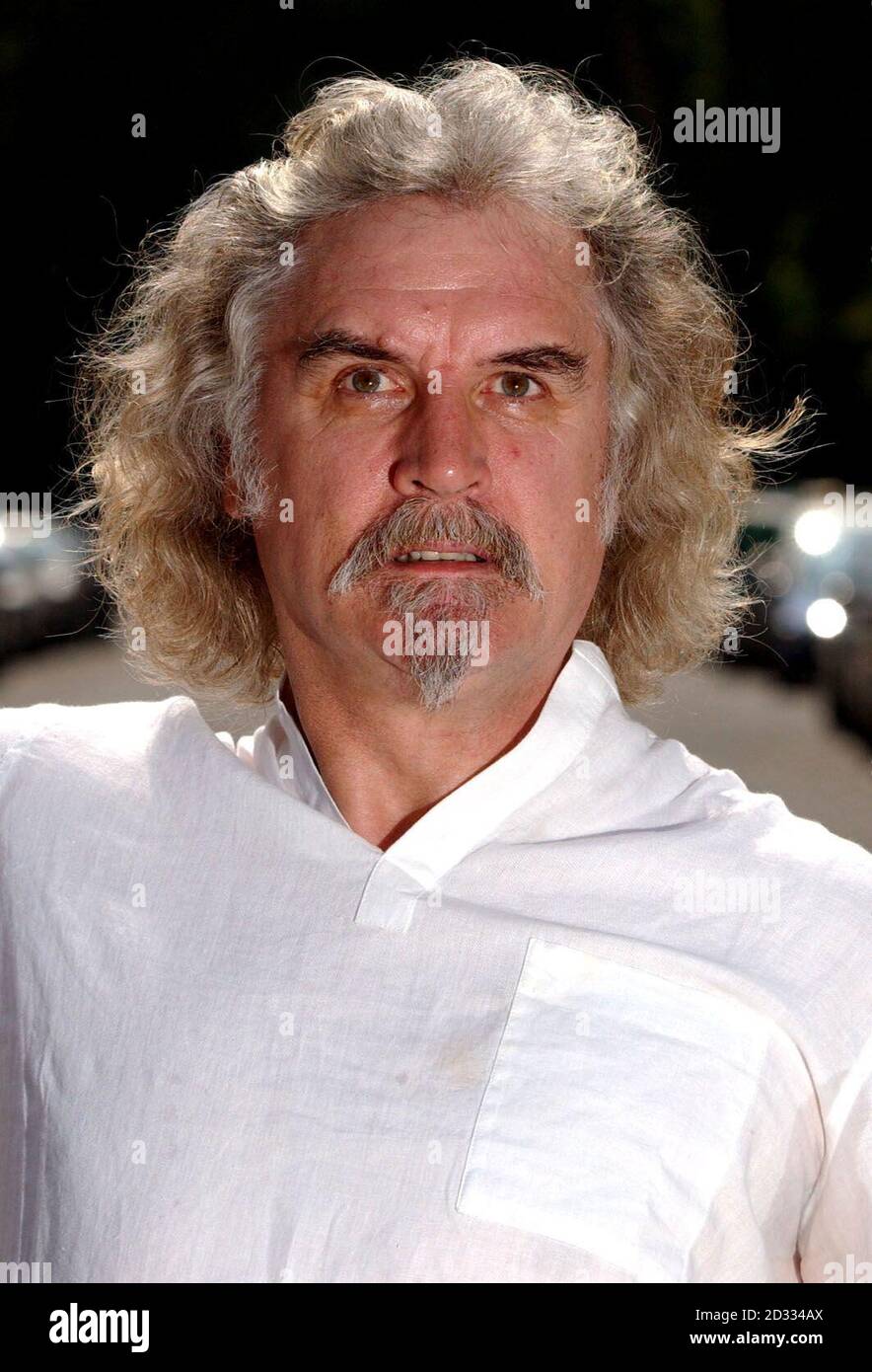 Actor and comedian Billy Connolly poses for photographers prior to a press conference for his new film 'The Man who Sued God' at St Mary's Church in Central London. The film premieres at the Warner West End Cinema in London's Leicester Square.  Stock Photo