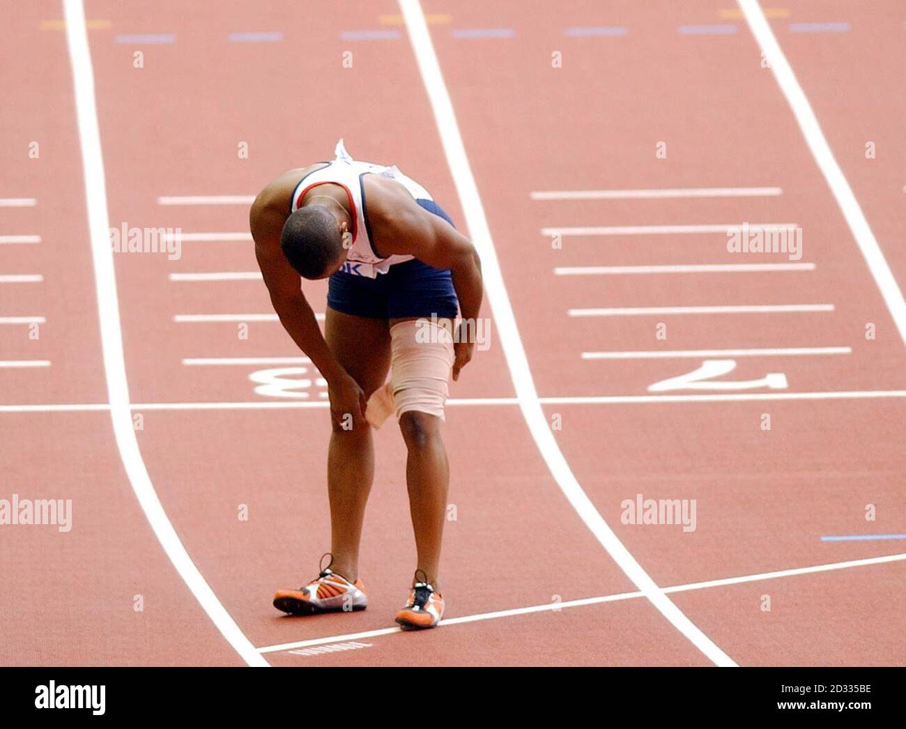 Great Britain's Darren Campbell wraps up his injured leg after finishing second behind the USA team in the men's 4x100 relay final at the Athletics World Championships in Paris. Stock Photo
