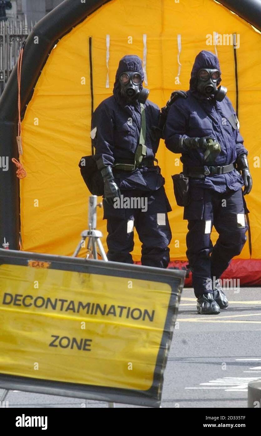 Police officers dressed in Personal Protective Equipment (PPE) attend a simulated terrorist attack in the centre of London. University College Hospital treated victims of the exercise, who went through a rigorous decontamination process surrounded by police and hospital staff in full protective gear. 06/04/2004: Police and the security services have foiled a terrorist plot to launch a poison gas attack in Britain, Tuesday April 6, 2004. A plan to use a highly toxic chemical called osmium tetroxide was uncovered after communications between terror suspects were monitored. Stock Photo