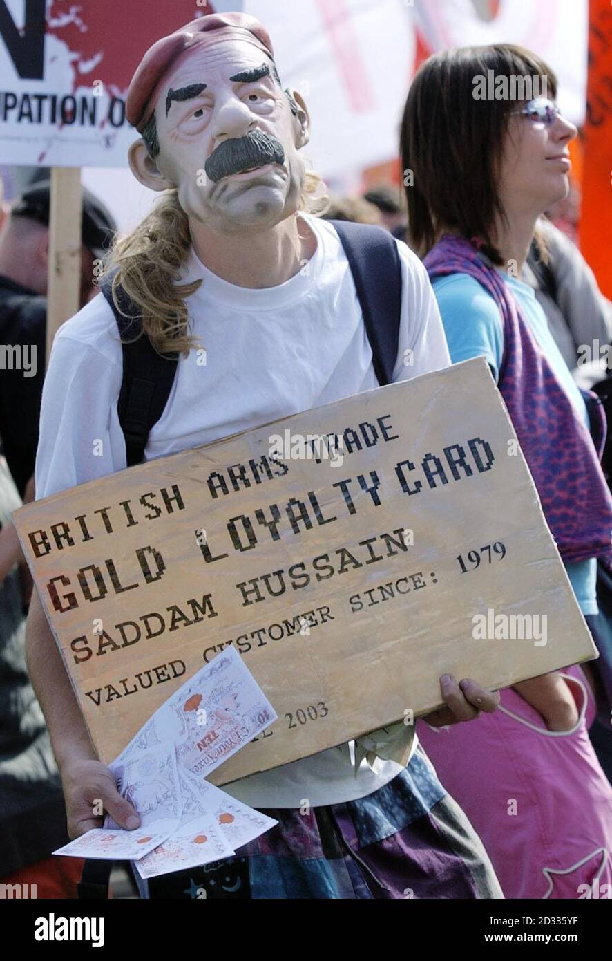 A protester demonstrates outside the ExCel exhibition centre in London's Docklands, where an international arms fair is taking place this week. The event, Europe's biggest arms show, opened today amid tight security, but protests were muted. Police arrested 51 people in the run up to the event and a further three people were detained this morning, but there were no attempts to break through security. The protesters are demonstrating against the sale of military arms around the world. Stock Photo