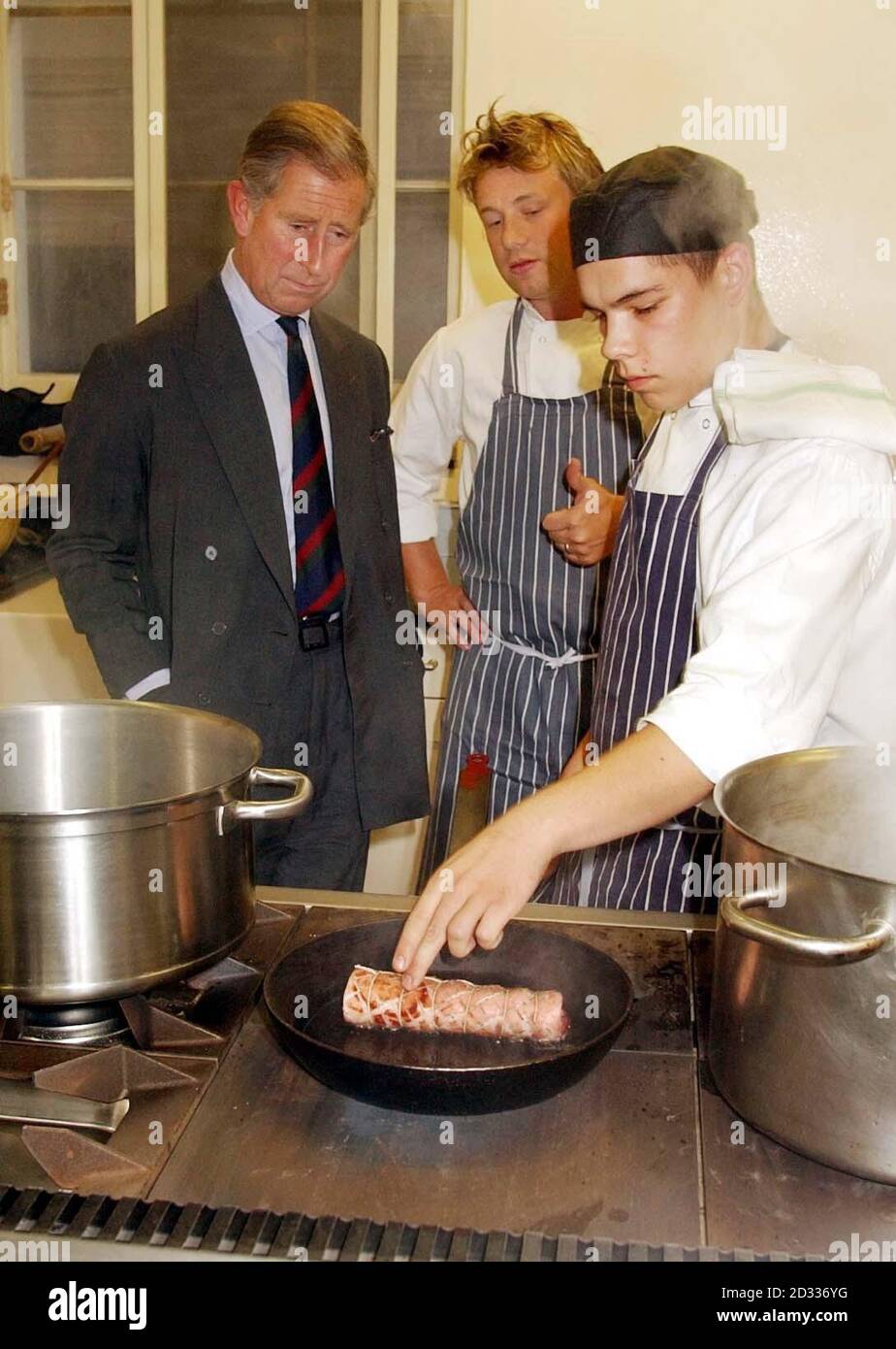 The Prince of Wales with Jamie Oliver one of his students in the kitchen of Clarence House, his official London residence. Celebrity chef Jamie Oliver is cooking up an organic feast for the Prince of Wales, helped by students from his restaurant Fifteen. The star, who is currently taking a year off TV to devote time to his family and the restaurant venture, will dish up dinner at Charles's official London residence Clarence House. The Prince is hosting the event for VIP guests, farmers and key players in the organic food industry to mark the progress of organic food over the last 10 years. Stock Photo