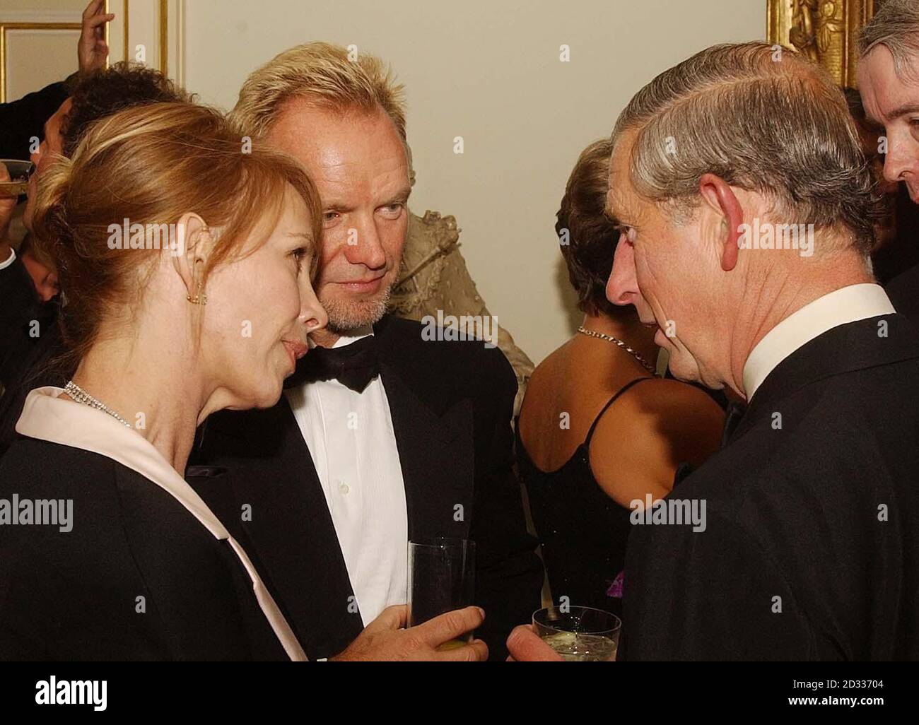 The Prince of Wales talks to pop star Sting and his wife Trudie Styler at a reception at Clarence House, his official London residence, where celebrity chef Jamie Oliver and his young team from the restaurant Fifteen cooked an organic feast for the Prince and VIP guests. The Prince was hosting the meal to mark the progress of organic food and farming over the last ten years. The Prince is an avid fan of organic farming and his own produce range Duchy Originals is one of the UK's leading organic food brands. Stock Photo