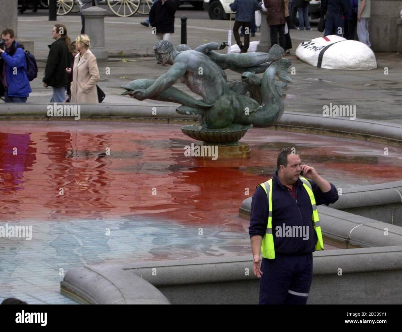 Red dye thrown in by demonstrators colours the water of a fountain in London's Trafalgar Square, during a protest over the State Visit by US President George W Bush. The President arrived in the UK Tuesday evening and was formally welcomed to the country Wednesday morning by The Queen.   Stock Photo