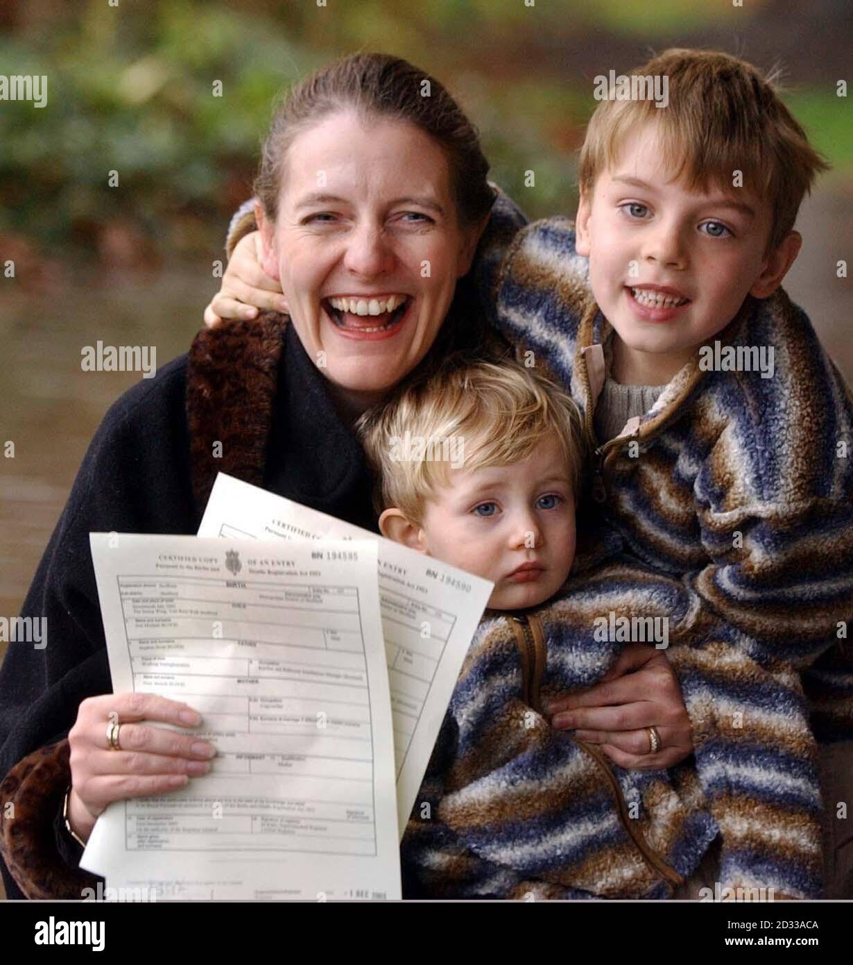 Diane Blood with sons Liam, four, and Joel, 16-months, shows birth certificates bearing the name of their father, outside Sheffield District Register Office, after Mrs Blood won her long legal battle to have her late partner Stephen, who died in 1995, legally recognised on the documents.The Human Fertilisation and Embryology (Deceased Fathers) Act 2003, which came into force today, gives mothers like Mrs Blood, whose children were conceived after their fathers' deaths, a six-month window in which to re-register their children's births if they now wish to name the deceased parent on the relevan Stock Photo