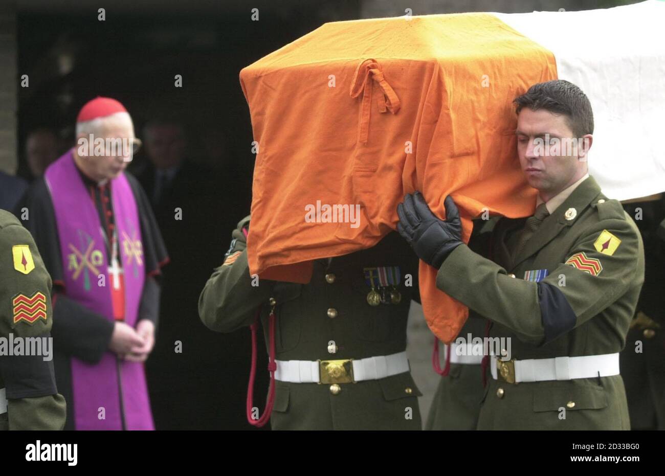 The coffin of Archbishop Michael Courtney, who was shot dead by anti-government rebels whilst carrying out Vatican business in Burundi, is carried, from Dublin airport chapel by the Second Brigade of the Irish Military Police, after a short service attended by family, An Taioseach Bertie Ahern and Cardinal Desmond Connell (left). The priest's car was sprayed with bullets in an attack blamed on rebel National Liberation Forces who have refused to support the peace process aimed at ending Burundi's civil war.  Stock Photo