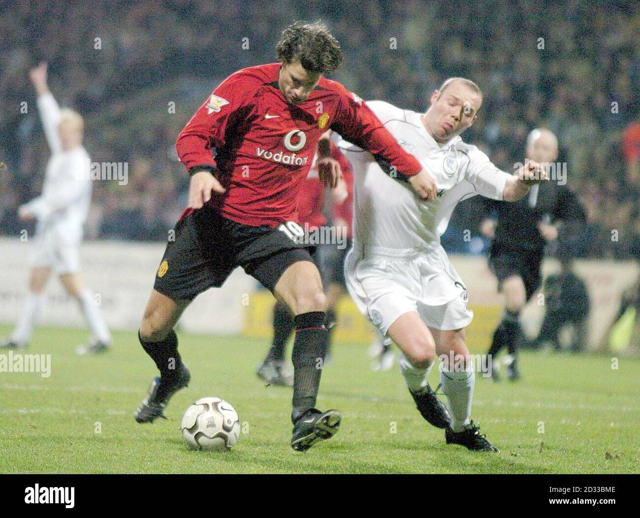Ruud Van Nistelrooy of Manchester United (left) holds off Simon Charlton of Bolton, during their Barclaycard Premiership match at The Reebok Stadium, Bolton.   THIS PICTURE CAN ONLY BE USED WITHIN THE CONTEXT OF AN EDITORIAL FEATURE. NO WEBSITE/INTERNET USE UNLESS SITE IS REGISTERED WITH FOOTBALL ASSOCIATION PREMIER LEAGUE. Stock Photo
