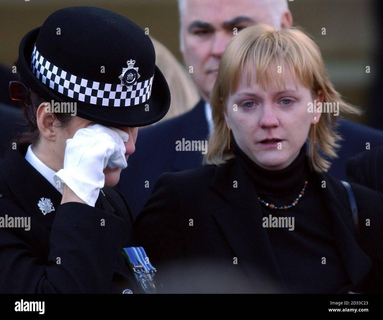 The widow of traffic policeman Ian Broadhurst, Eilisa (right), stands with officers, at Leeds Parish Church, West Yorkshire as  hundreds of mourners joined to bid a final farewell to her husband. Pc Broadhurst, 34, from Birkenshaw, West Yorkshire, was shot twice while helping to arrest American David Bieber in Dib Lane, Leeds on Boxing Day 2003.The funeral began with around 800 people packed into the church and hundreds more outside watching the ceremony on a large video screen.  2/12/04: Former US Marine David Bieber, a bouncer and steroid abuser who is wanted in the US for a murder plot, was Stock Photo