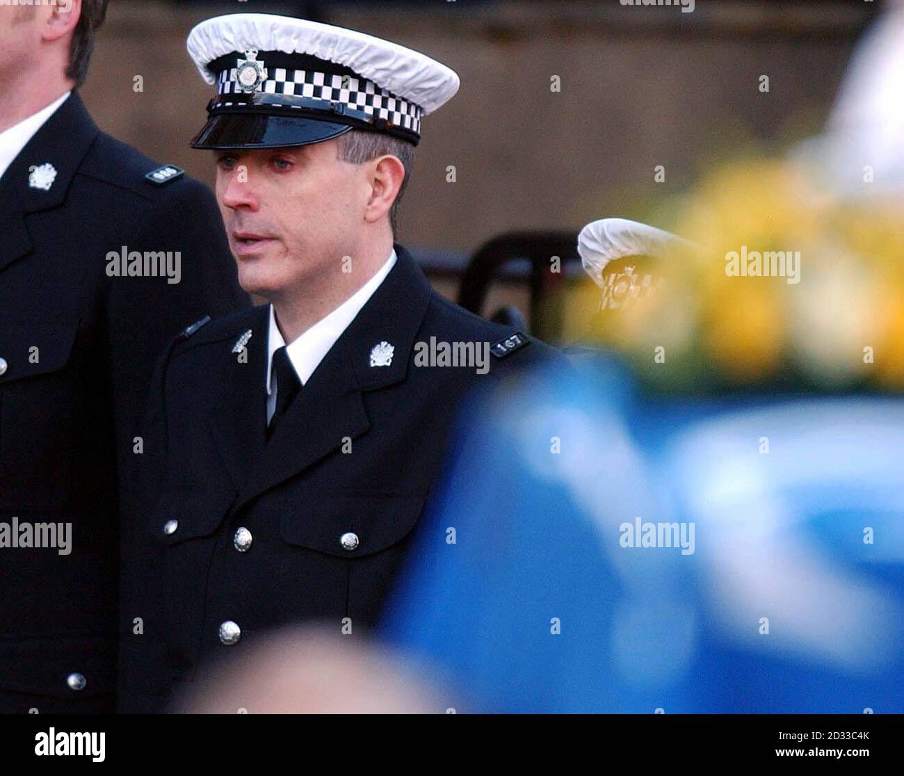 PC Neil Roper holds his hand to his face during the funeral of murdered colleague Ian Broadhurst at Leeds Parish Church.  Stock Photo