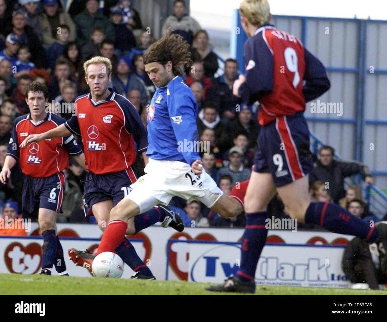 Patrik Berger of Portsmouth (centre) evades Scunthorpe's Ian Kilforda (second left), during the FA Cup 4th rd match at Fratton Park, Portsmouth.  THIS PICTURE CAN ONLY BE USED WITHIN THE CONTEXT OF AN EDITORIAL FEATURE. NO UNOFFICIAL CLUB WEBSITE USE. Stock Photo