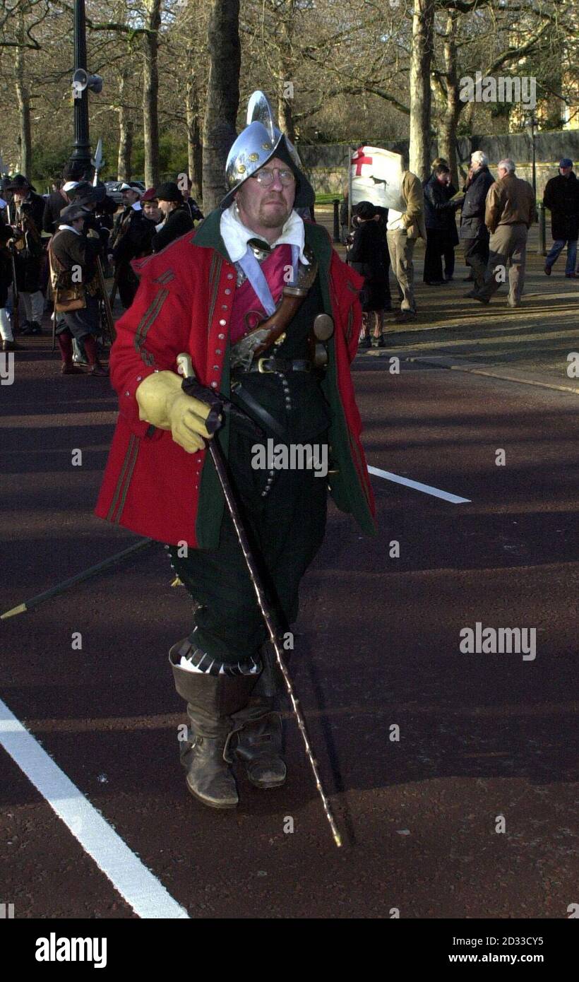 Andrew Newton of Sir William Pennymans Regiment, strikes a dashing pose as he waits to lead his Regiment up The Mall. He is wearing a polished Spanish Combe Morion, a type of helmet still seen during the early part of the Civil War, two wheel-lock carbine pistols tucked into his belt, a sword and a replica 17th century walking stick. The King's Army has held this march, to commemorate the execution of Charles I, in Central London on the last weekend in January for the past 32 years, and it is now recognised as a Custom of London. Stock Photo