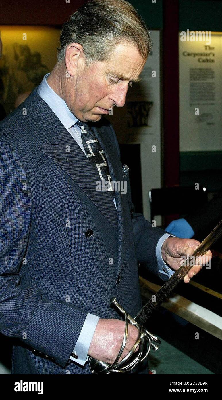 The Prince of Wales examines a replica of a 16th century basket-hilted sword from the wreck of the Mary Rose during a visit to Portsmouth's historice dockyards. Prince Charles visited the wreck of the historic warship the Mary Rose which he helped to raise from the sea bed.Charles toured the Mary Rose Museum in Portsmouth's Historic Dockyard to mark the silver jubilee anniversary of the Mary Rose Trust. Stock Photo