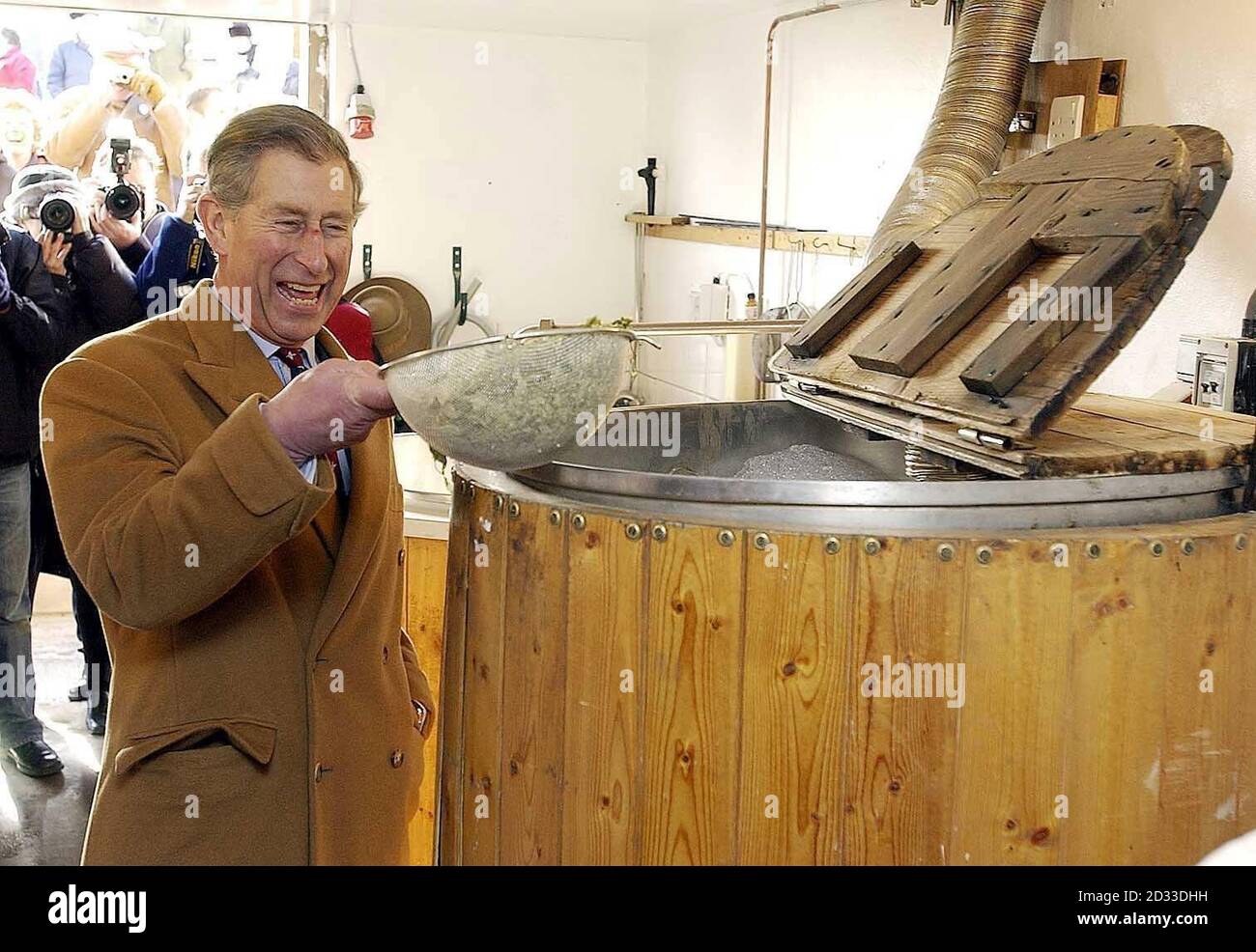 The Prince of Wales adds hopps to a vat at the village microbrewery during a visit to Newmarket Village, Hesket, Cumbria. Stock Photo