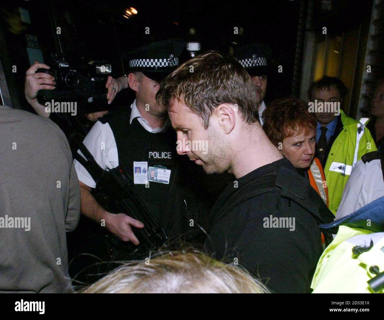 Leicester City player Danny Coyne leaving Luton Airport after flying back to the UK from Spain after being released by a Spanish court. Leicester City manager Micky Adams refused to speak to waiting reporters as his players were ushered by police from a side door at Luton Airport into a waiting minibus. Stock Photo