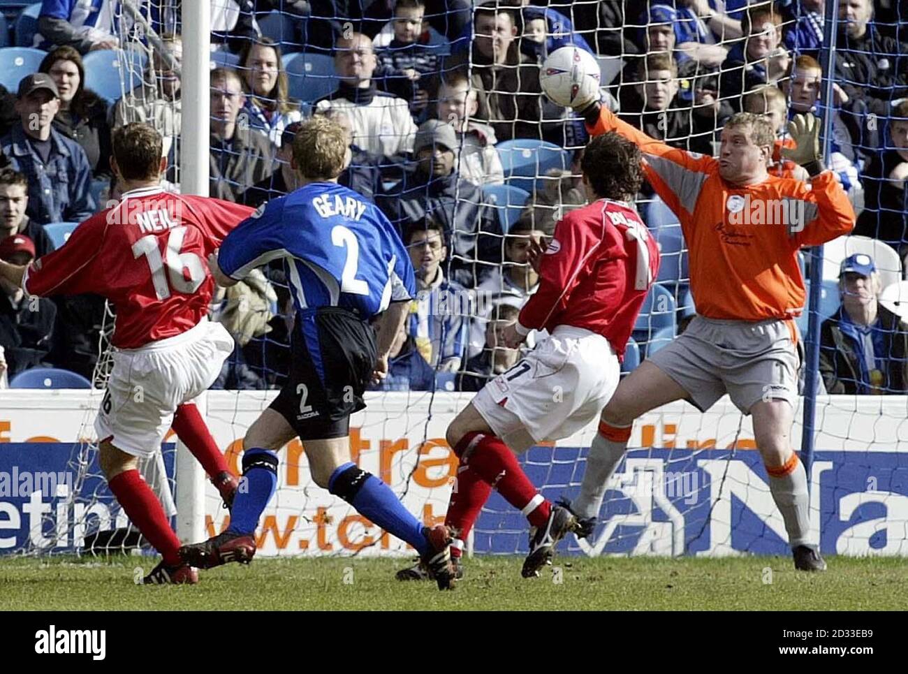 Sheffield Wednesday goalkeeper Kevin Pressman saves from Barnsley's Alex Neil (L) during the Nationwide Division Two match at Hillsborough, Sheffield.  THIS PICTURE CAN ONLY BE USED WITHIN THE CONTEXT OF AN EDITORIAL FEATURE. NO UNOFFICIAL CLUB WEBSITE USE. Stock Photo