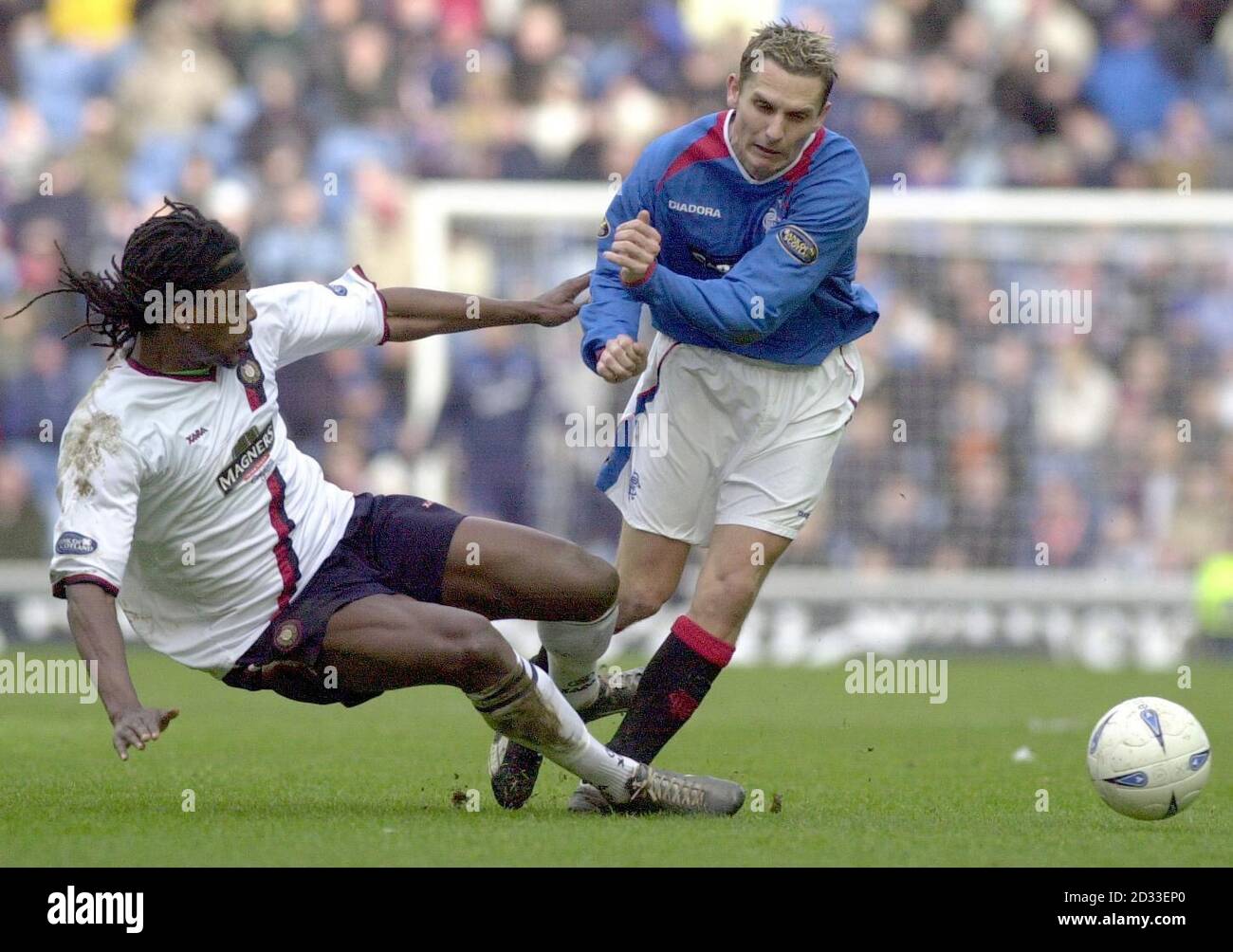 Ranger's Peter Lovenkrands (right) is challenged by Dundee's  Brent Sancho, during their Bank of Scotland Scottish Premiership match at Ibrox Stadium,  Glasgow Saturday March 20 2004.   EDITORIAL USE ONLY Stock Photo