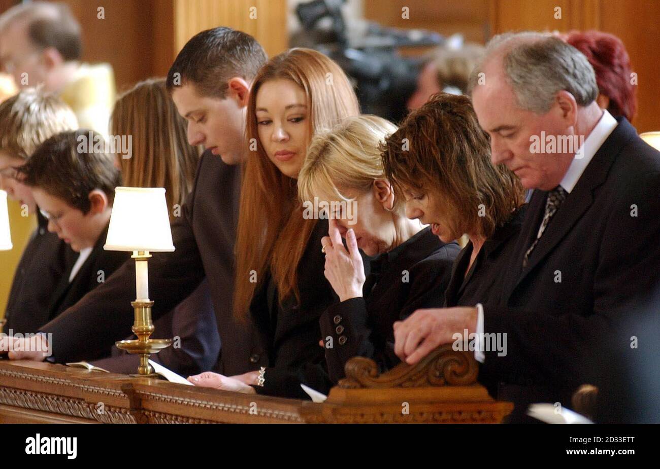 Mrs Lynn Lloyd wipes away a tear, watched by her daughter Chelsea (4th right), during a special service to celebrate the life and work of her late husband Terry Lloyd of ITN (Independant Television News), held at St Brides Church, Fleet Street London. The 51-year-old broadcast veteran was killed on the road to Basra just days into the war in Iraq. Stock Photo