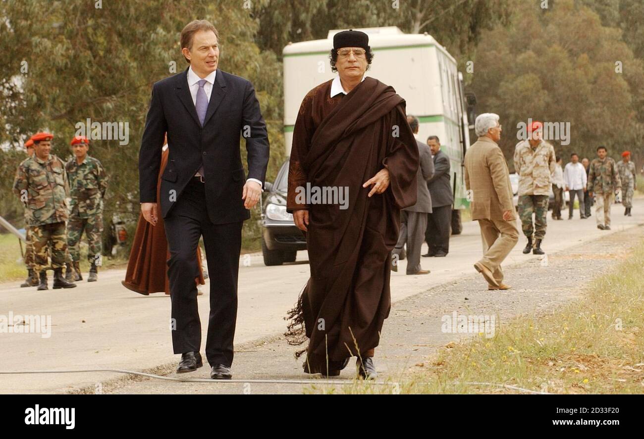 Prime Minister Tony Blair and Libyan leader Colonel Muammar Gaddafi during an hour long break of their talks, stroll together to a separate tent for a lunch in Tripoli. Mr Blair's visit follows Libya's agreement in December to dismantle its WMD programme and its acceptance of responsibility for the Lockerbie bombing and the murder of Wpc Yvonne Fletcher. Stock Photo