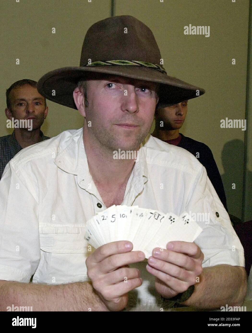 Major Jonathan Simms holds a pack of playing cards as he speaks to journalists on his arrival at Heathrow Airport.  He and five other potholers made the cards to pass the time while waiting to be rescued after they became trapped by rising flood waters in caves at Cuetzalan, north-east of Mexico City.  Stock Photo
