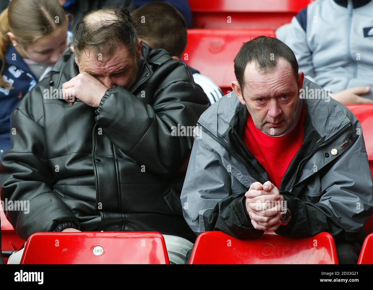 Football fans clearly emotional during a memorial service held at the Kop stand of Liverpool Football Club's Anfield stadium,  on the 15th anniversary of the Hillsborough disaster.  A candle was lit for each of the 96 victims who were crushed to death on the Leppings Lane terrace of Sheffield Wednesday's Hillsborough ground during Liverpool's 1989 FA Cup semi-final clash.  Stock Photo