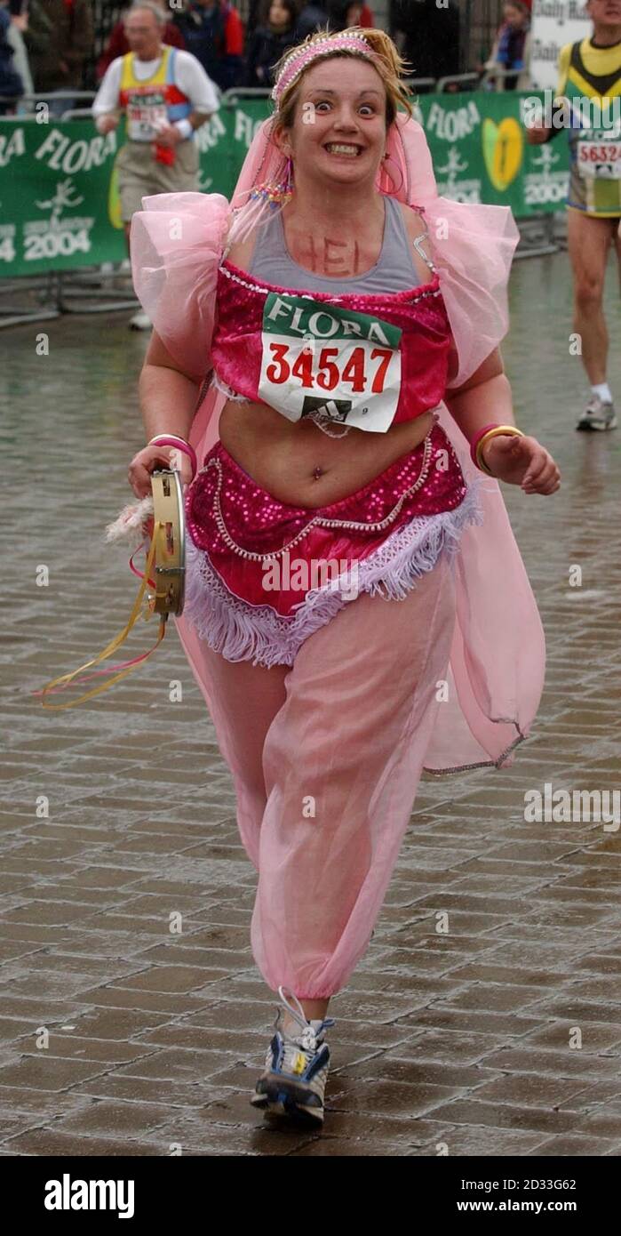 A runner dressed as a belly dancer runs at the start of the 2004 London