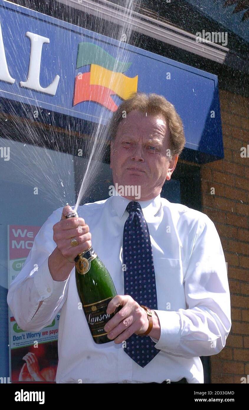 Ron Nicholson, 51, of Poole, Dorset, celebrates at a Coral bookmakers in Bournemouth Friday April 23, 2004, after winning the biggest individual payout since betting shops were legalised in 1961 by picking the winners of six horse races which took place last Saturday. But the hotel manager, who was made redundant just weeks before he entered betting history by scooping  878,939 from a  4 stake, said that he hoped that his winnings would not change his life. He could double his money if he predicts the winner Saturday of the feature race at Sandown Park in the Betfred Gold Cup Stock Photo