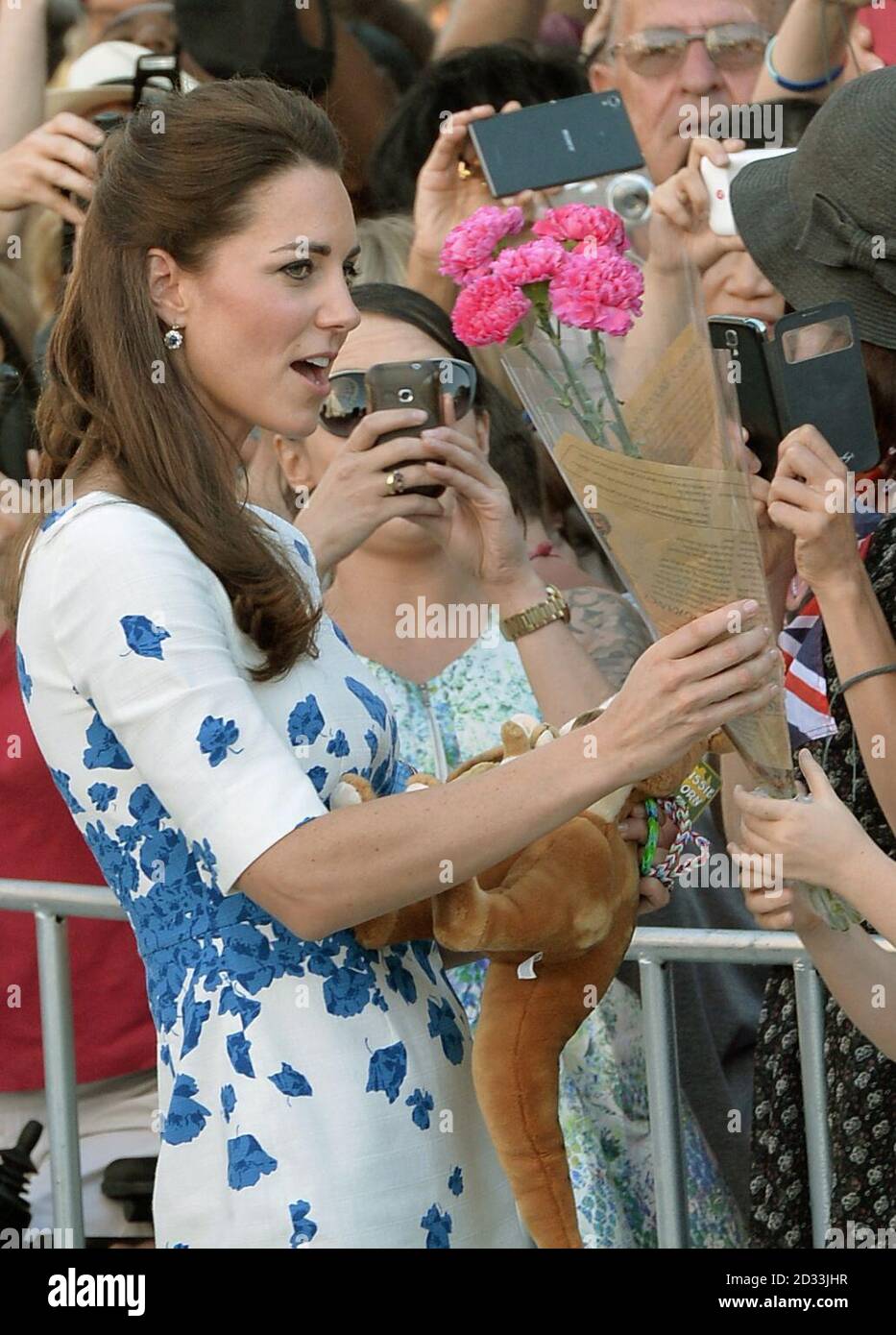 The Duchess of Cambridge receives flowers as the Duke and Duchess of Cambridge meet well wishers in Brisbane following a reception hosted by the Governor and Premier of Queensland during the thirteenth day of their official tour to New Zealand and Australia. Stock Photo