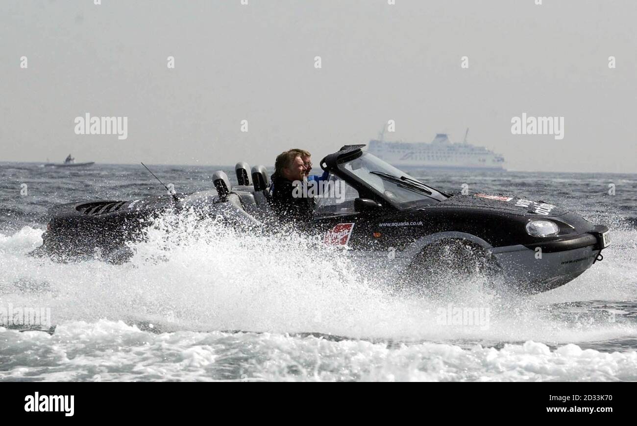 Sir Richard Branson (closest to camera) passes a ferry while making a  successful attempt on the record for crossing the English Channel in an  amphibious vehicle. Using an Aquada - which can