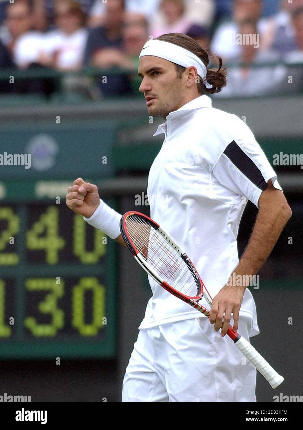 Defending champion Roger Federer clenches his fist after winning a crucial  point against Alejandro Falla from Columbia at The Lawn Tennis Championships  in Wimbledon, London Stock Photo - Alamy
