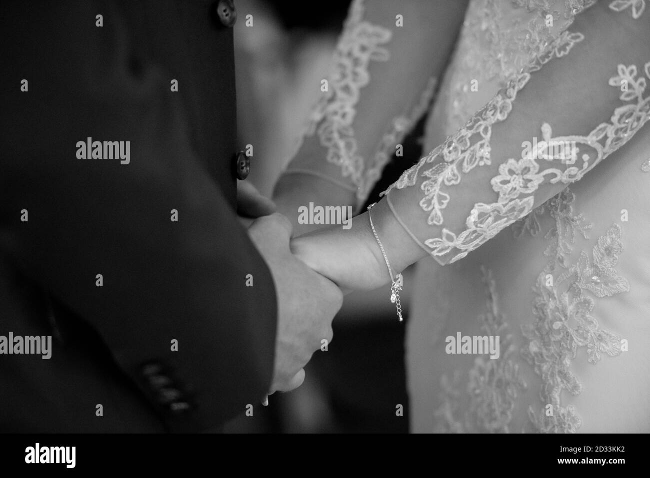 Wedding Couple holding hands close up in black and white Stock Photo