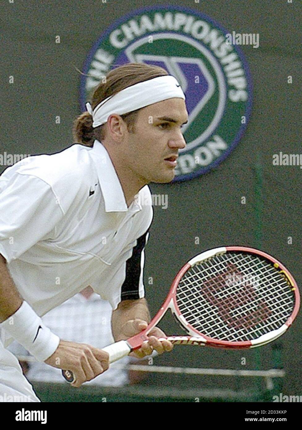 Defending champion Roger Federer from Switzerland in action against Ivo  Karlovic from Croatia at the Lawn Tennis Championships in Wimbledon,  London. EDITORIAL USE ONLY, NO MOBILE PHONE USE Stock Photo - Alamy