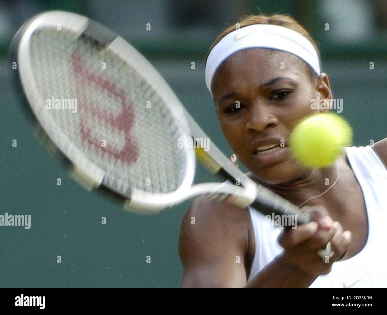 Defending champion Serena Williams from the USA in action against Amelie Mauresmo from France in the semi-final of the Ladies' Singles tournament of The Lawn Tennis Championships at Wimbledon, London Stock Photo