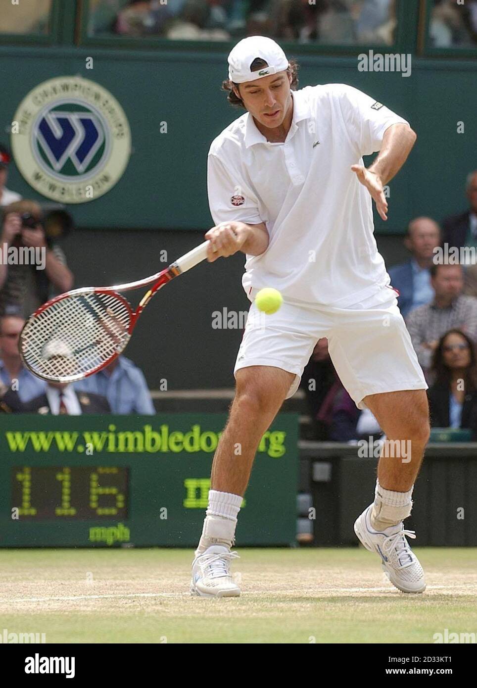 Sebastien Grosjean from France in action against the defending champion  Roger Federer from Switzerland in the semi-final of the Men's Singles  tournament at The Lawn Tennis Championships at Wimbledon, London. EDITORIAL  USE