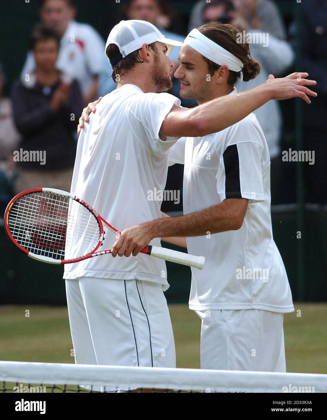 Roger Federer from Switzerland (right) and Andy Roddick from the USA  embrace after the final of the Men's Singles tournament at The Lawn tennis  Championships at Wimbledon, London. Final score 4:6/7:5/7:6/6:4 to